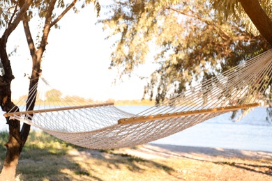 Photo of Empty comfortable hammock on beach. Summer vacation
