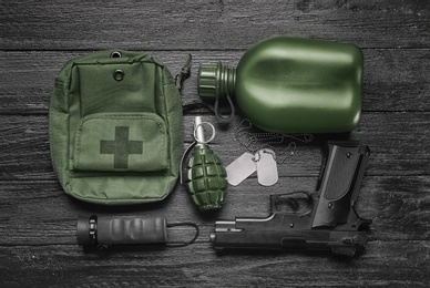 Set of military outfit on wooden background, flat lay