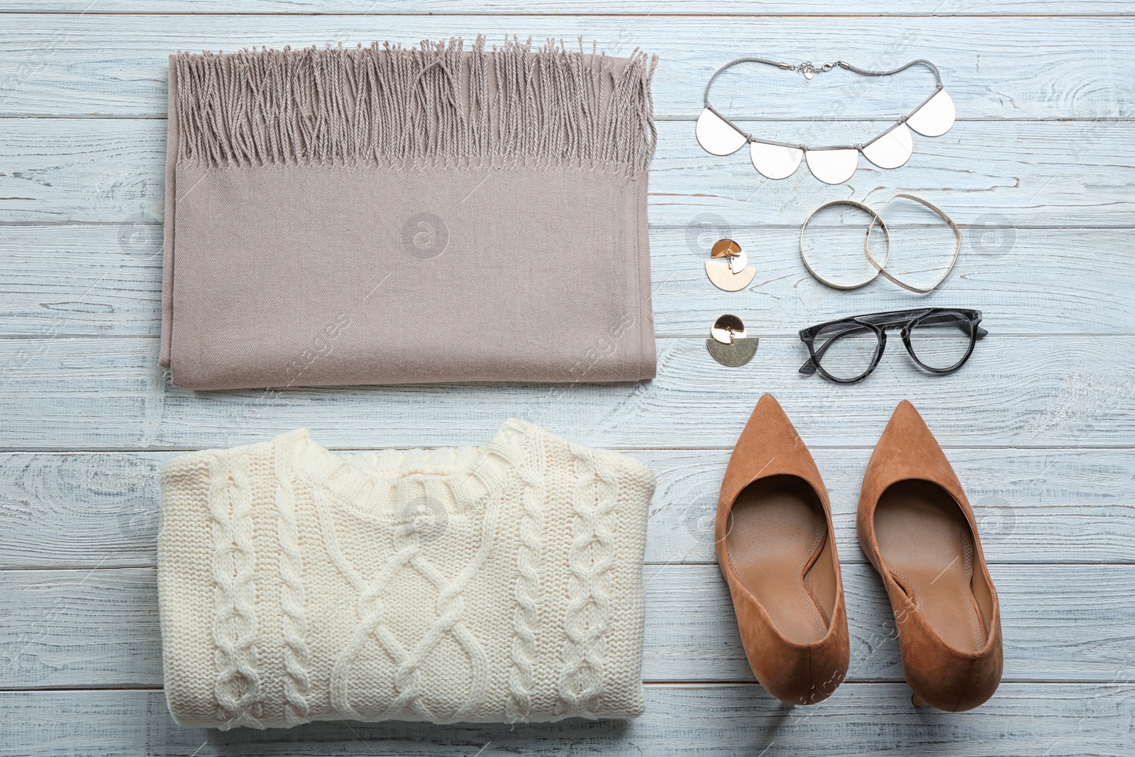 Photo of Flat lay composition with warm clothes on white wooden background