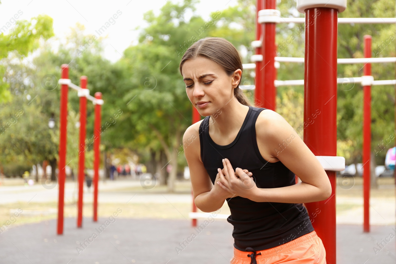 Photo of Young woman having heart attack on sports ground