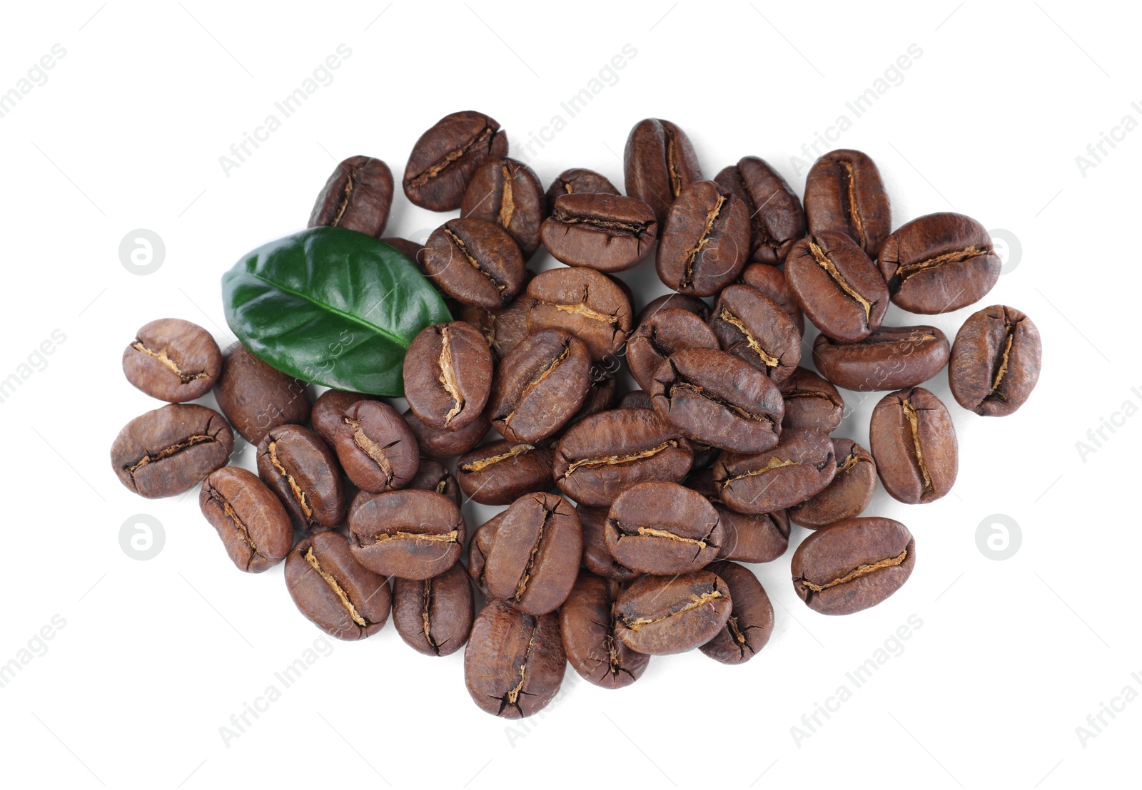 Photo of Pile of roasted coffee beans with fresh leaf on white background, top view