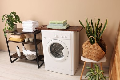 Stylish laundry room with modern washing machine. Interior design