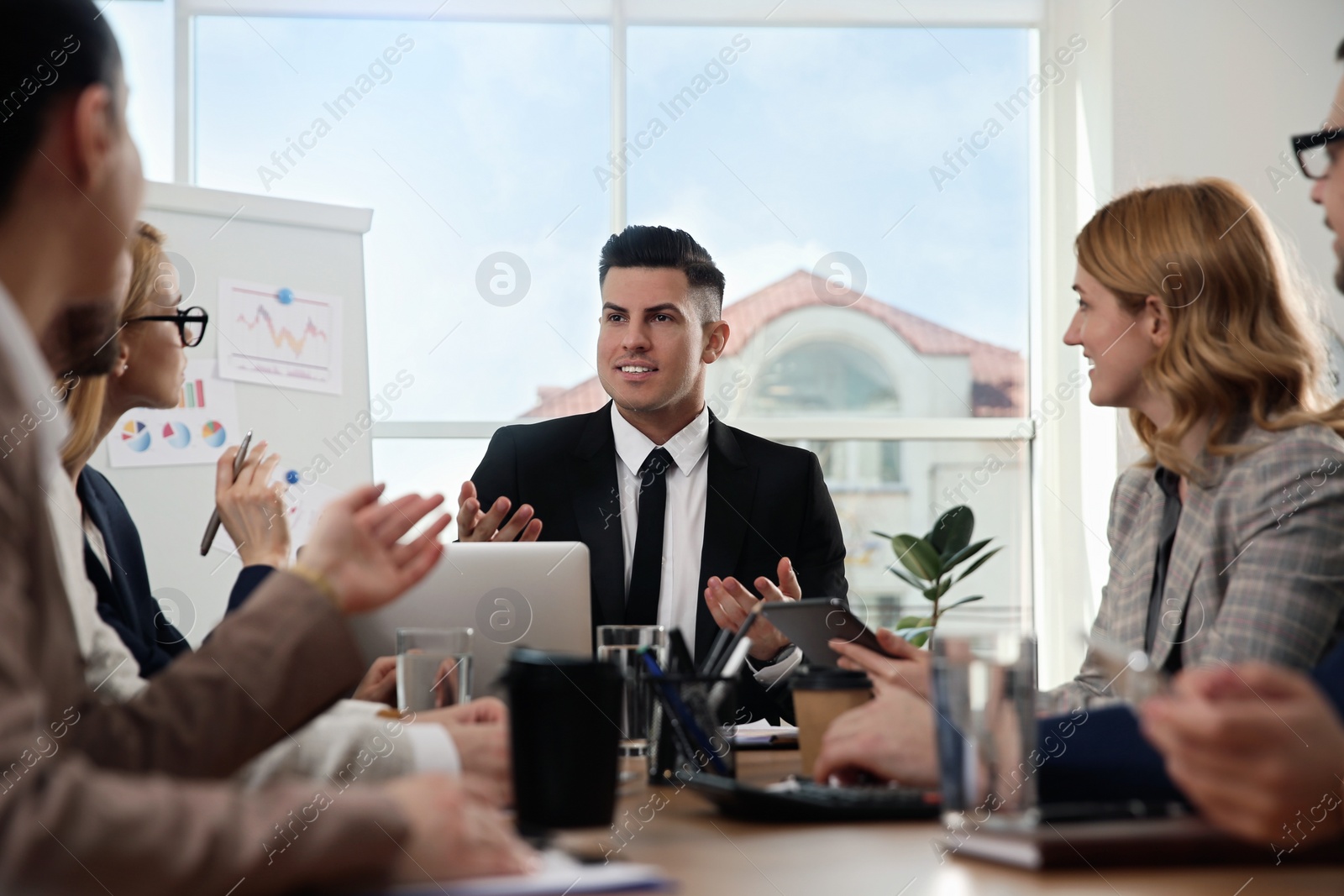 Photo of Businesspeople having meeting in office. Management consulting