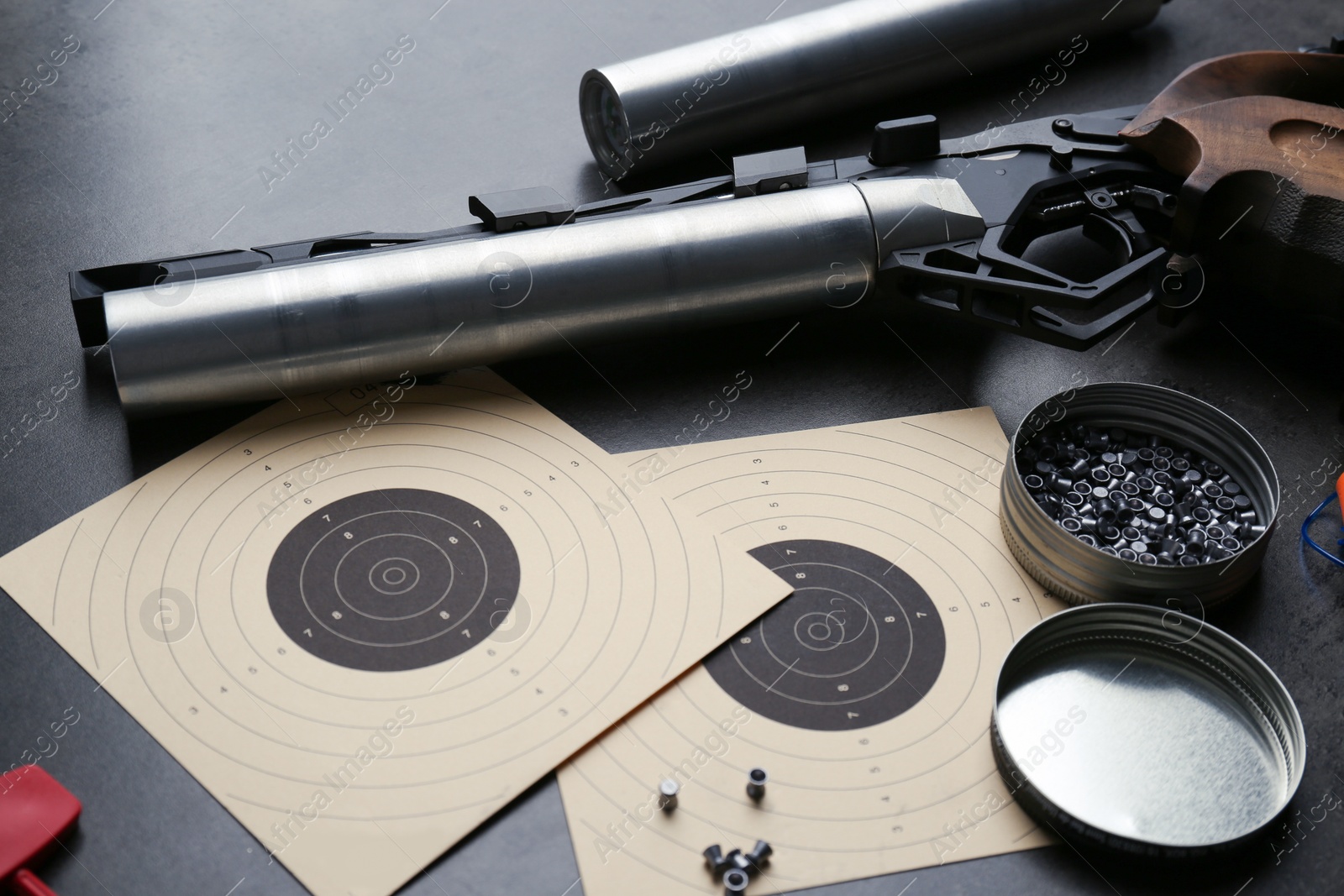 Photo of Composition with sport pistol on black table. Professional gun