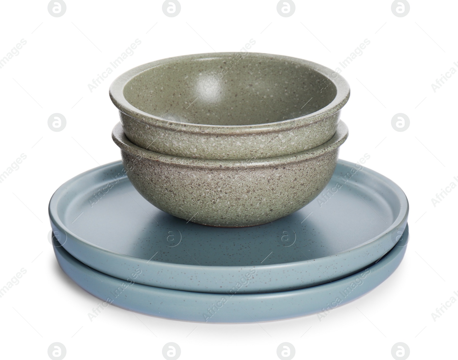 Photo of Grey ceramic plates and bowls on white background