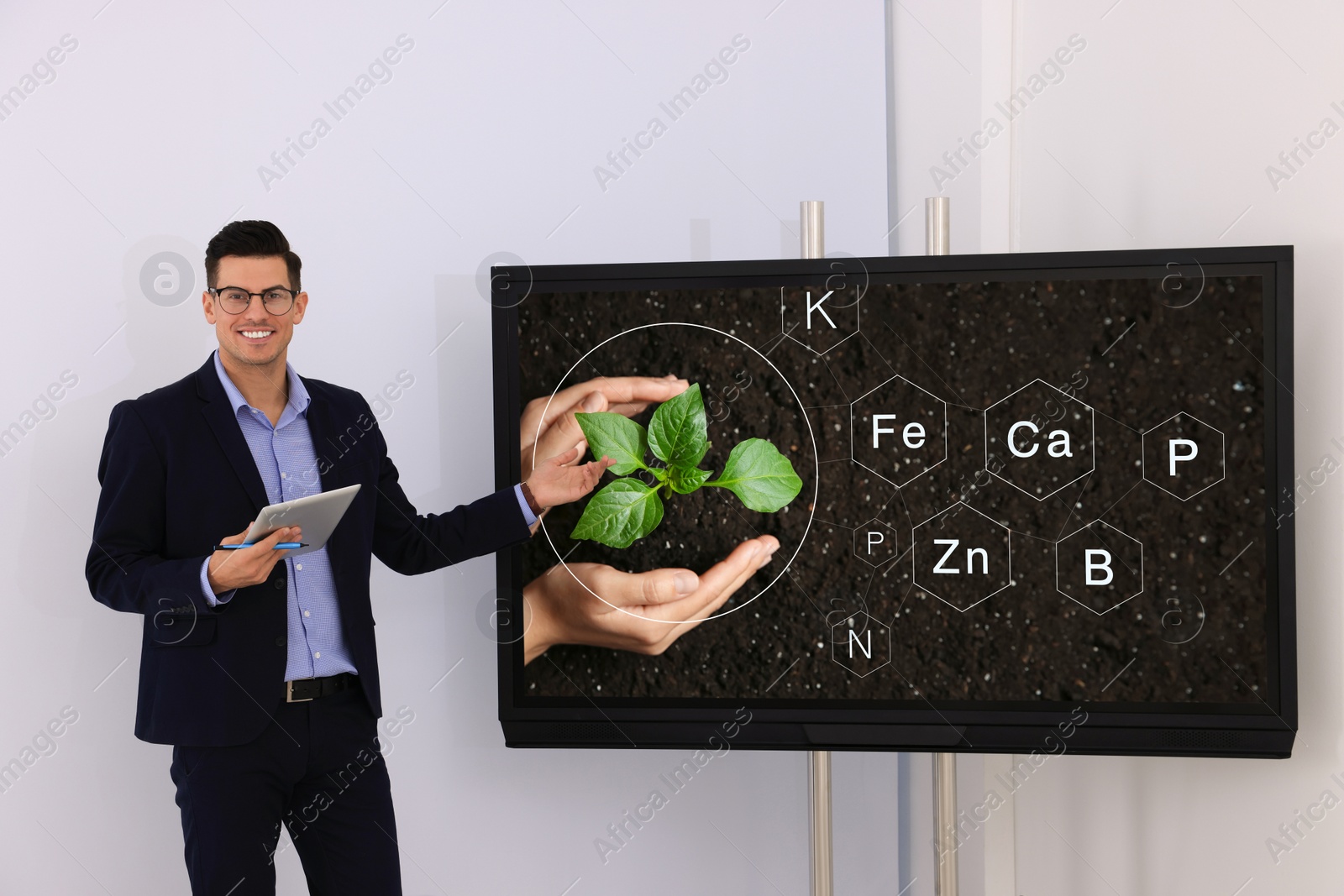 Photo of Teacher using interactive board in classroom during lesson