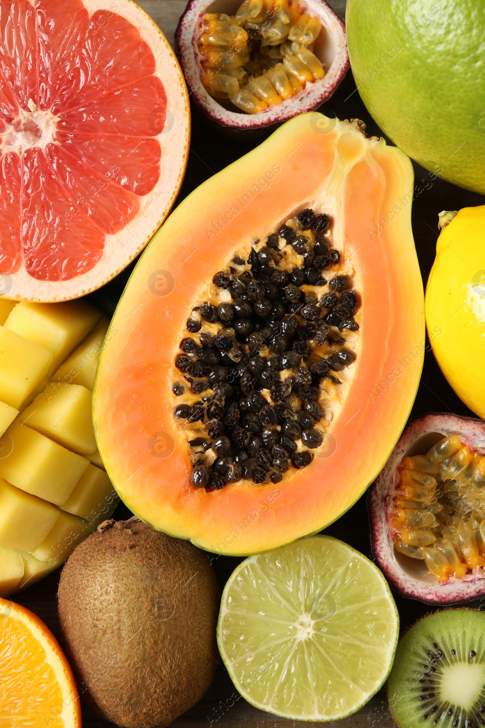 Photo of Fresh ripe papaya and other fruits on table, top view