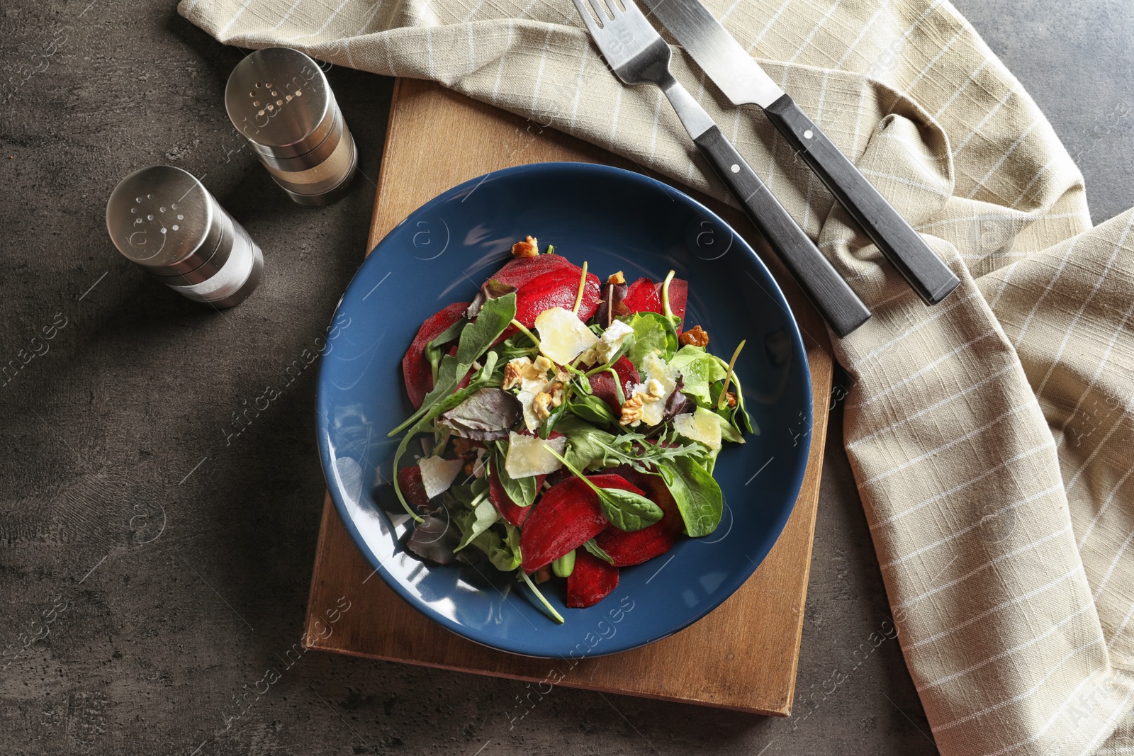 Photo of Plate with delicious beet salad served on table, top view