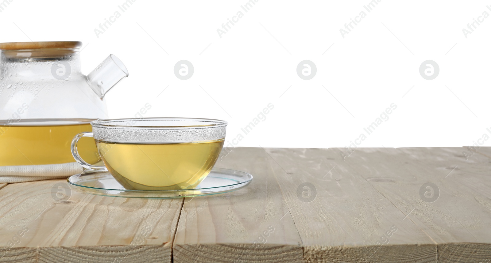 Photo of Refreshing green tea in cup and teapot on wooden table against white background