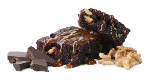 Delicious chocolate brownies with nuts and caramel sauce on white background