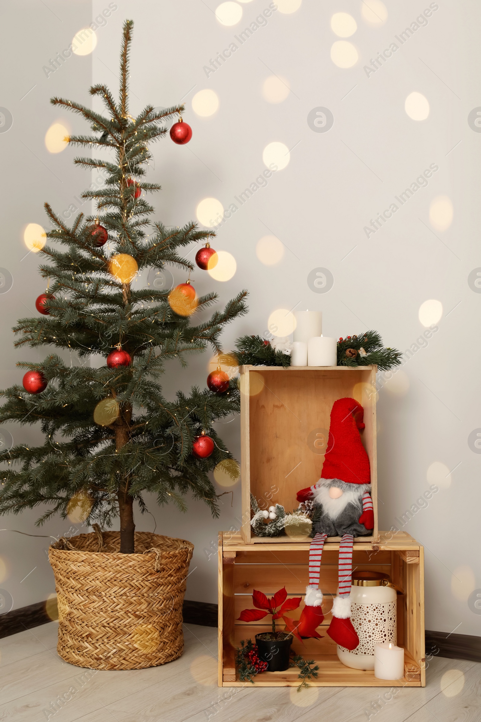 Photo of Christmas tree with red balls and festive decoration indoors