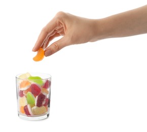 Photo of Woman taking gummy candy from glass on white background, closeup