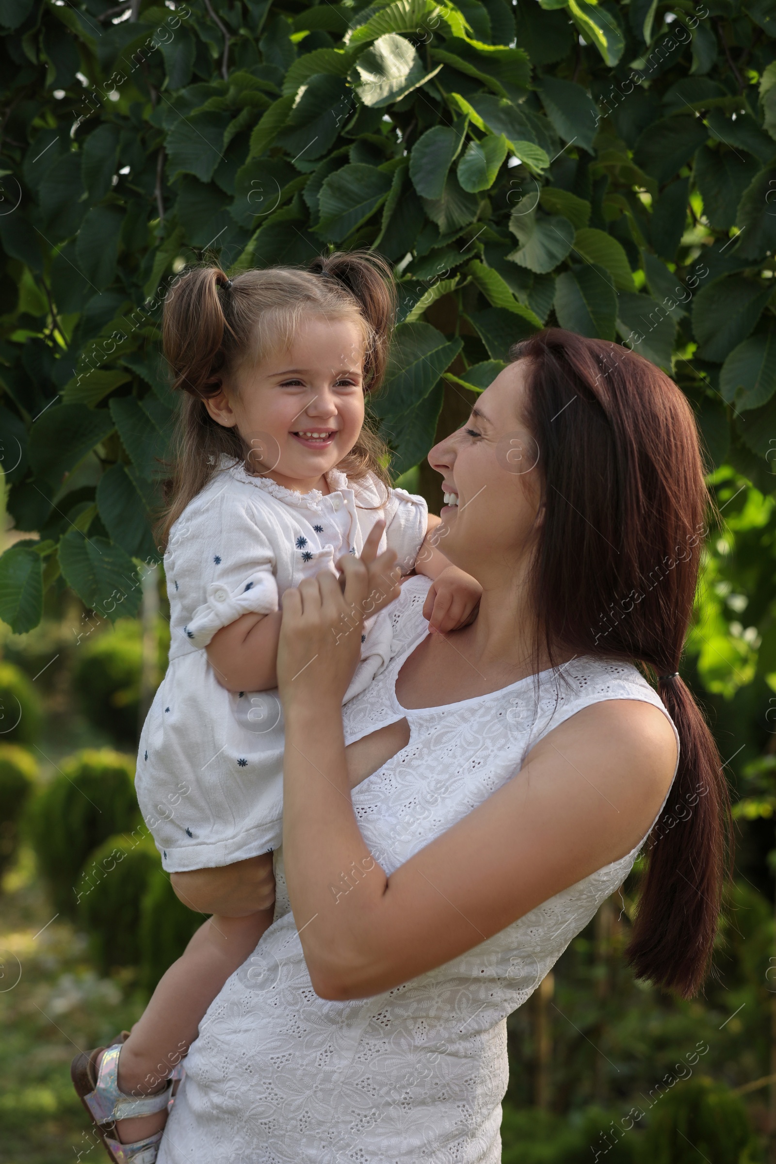 Photo of Happy mother with her cute daughter spending time together in park