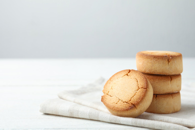 Sweet delicious butter cookies on white table. Space for text