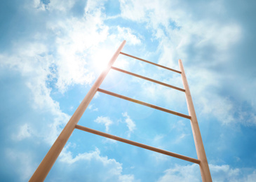 Image of Wooden ladder against blue sky with clouds, low angle view