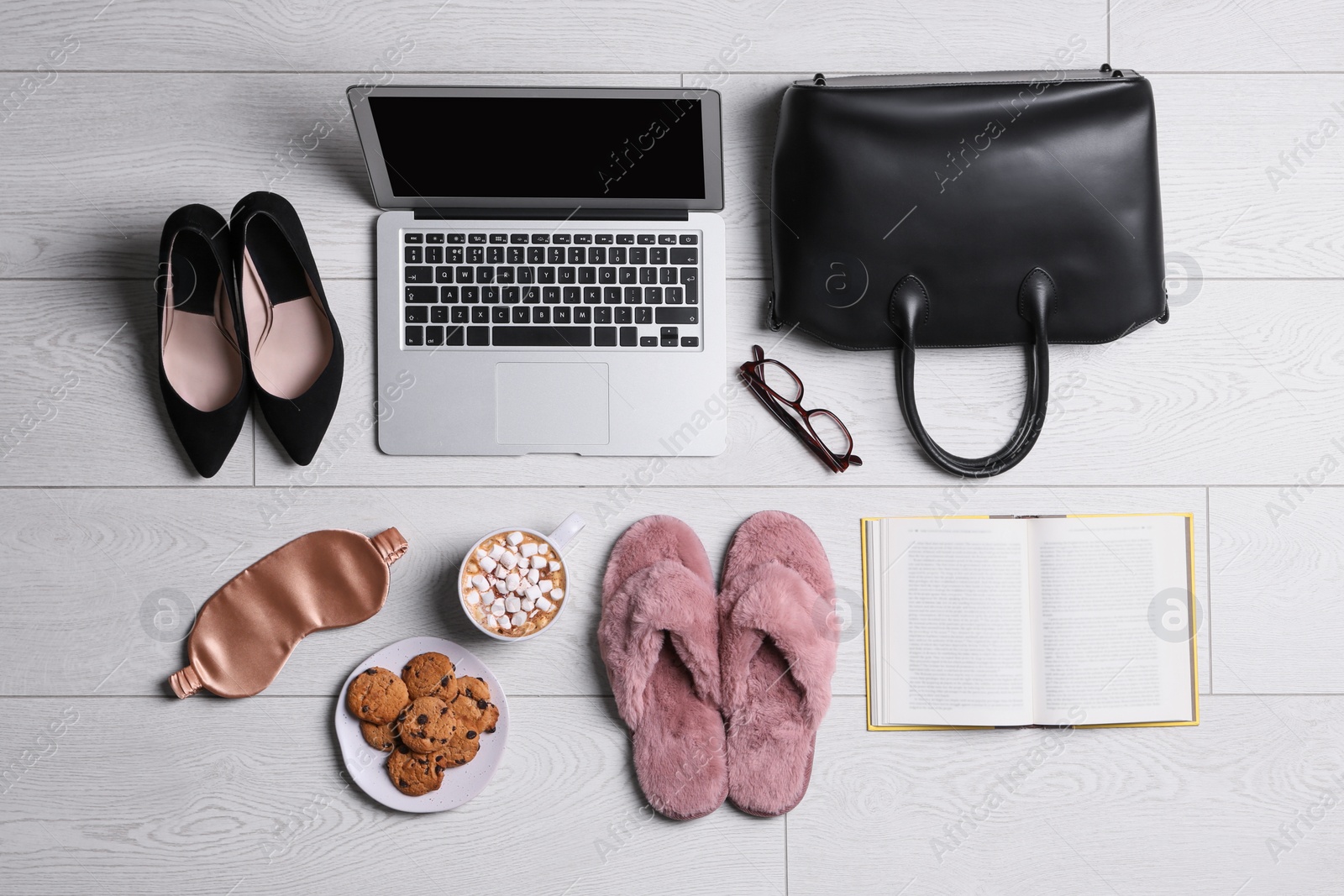 Photo of Flat lay composition with business supplies and home accessories on white wooden floor. Concept of balance between work and life