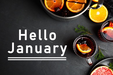 Image of Hello January greeting card. Flat lay composition with tasty mulled wine on black table