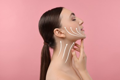 Woman with perfect skin after cosmetic treatment on pink background. Lifting arrows on her neck and face