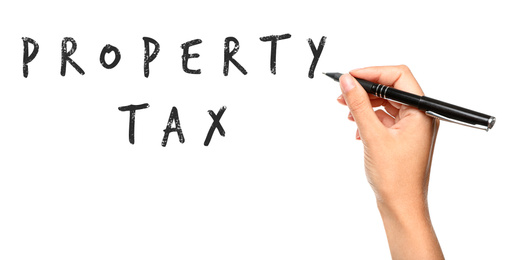 Woman writing phrase Property Tax on white background, closeup. Banner design