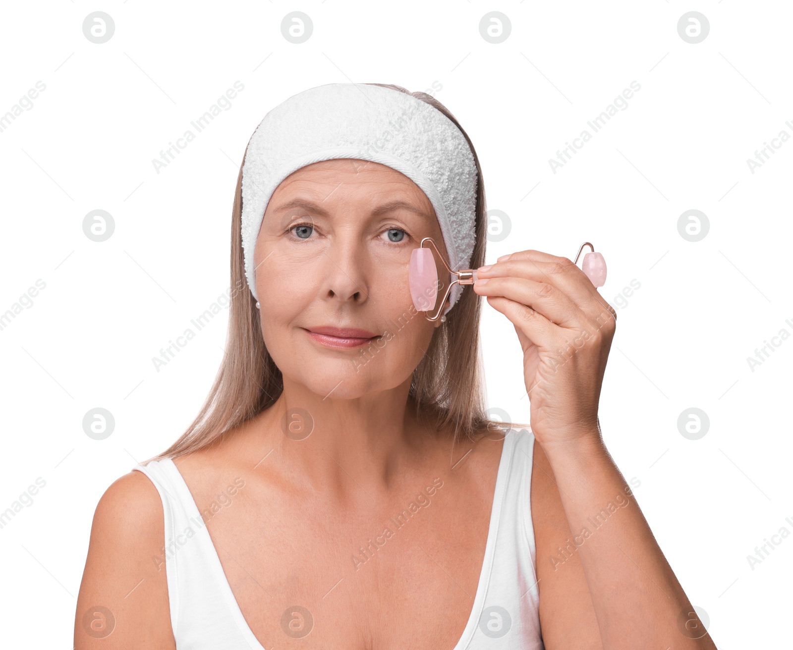 Photo of Woman massaging her face with rose quartz roller isolated on white