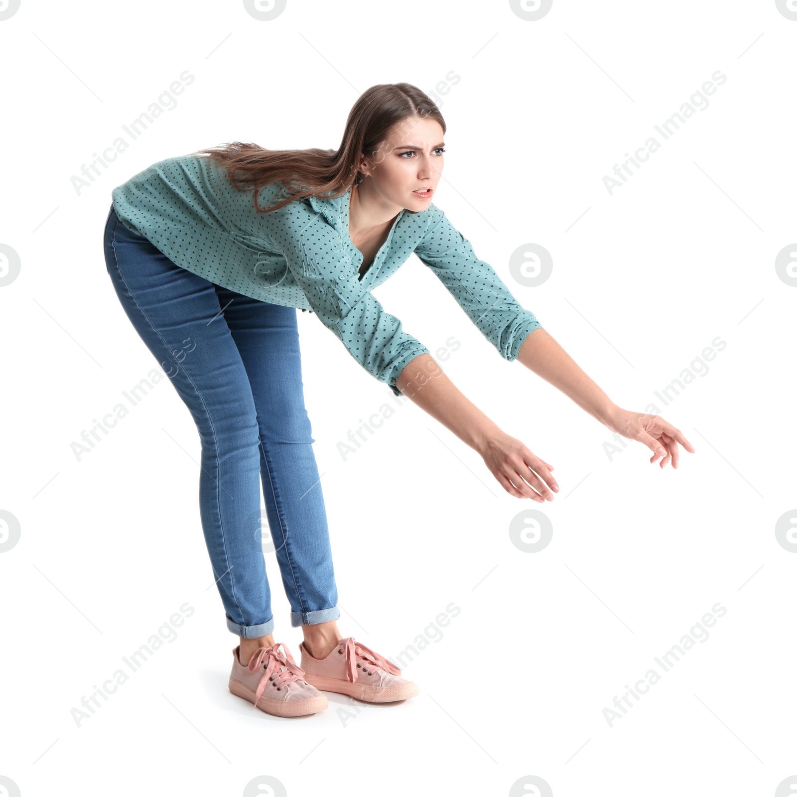 Photo of Young woman attracted to magnet on white background