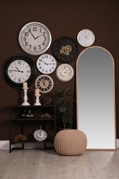 Photo of Stylish room interior with collection of wall clocks