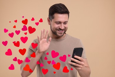 Image of Long distance love. Man video chatting with sweetheart via smartphone on grey background. Hearts flying out of device