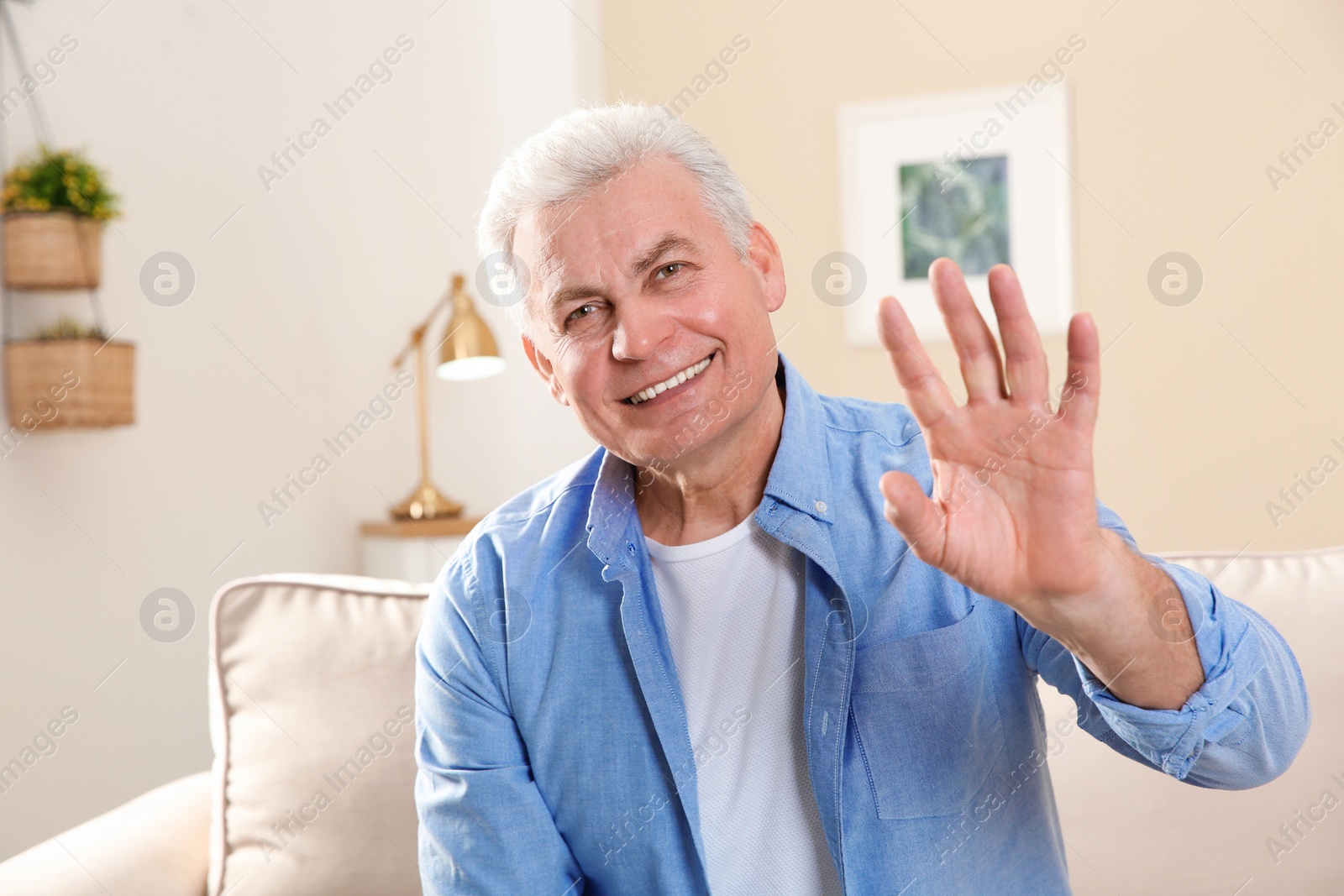 Photo of Mature man using video chat at home, view from web camera