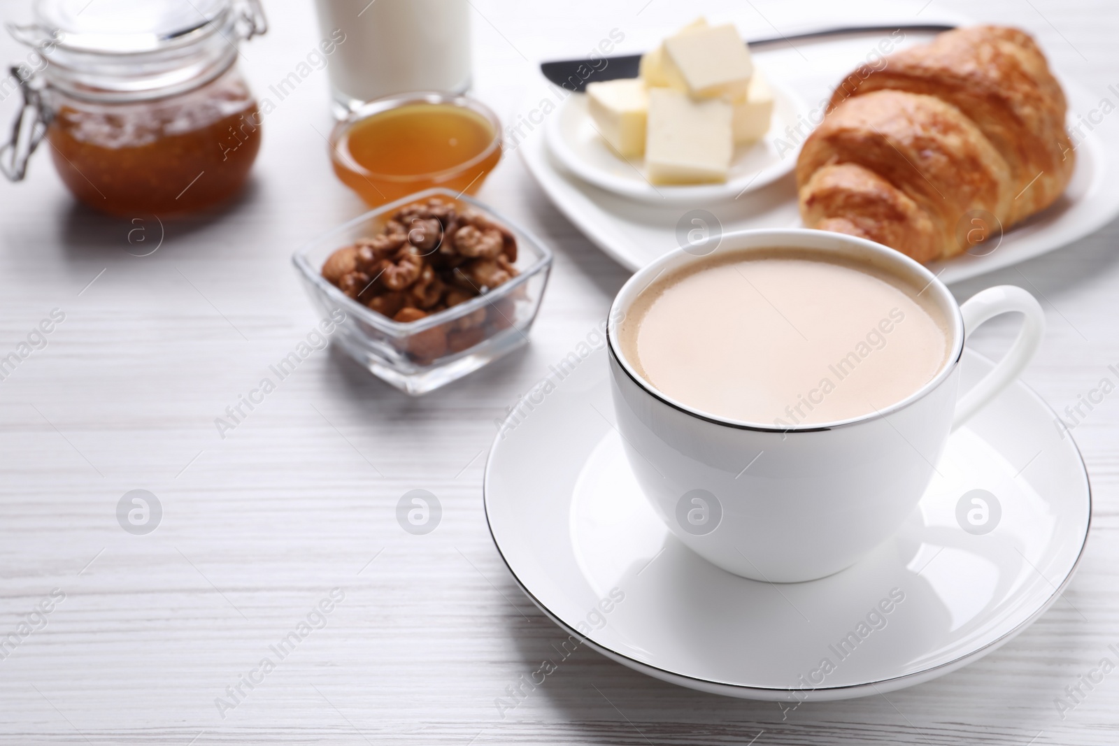 Photo of Delicious breakfast with cup of coffee on white wooden table. Space for text