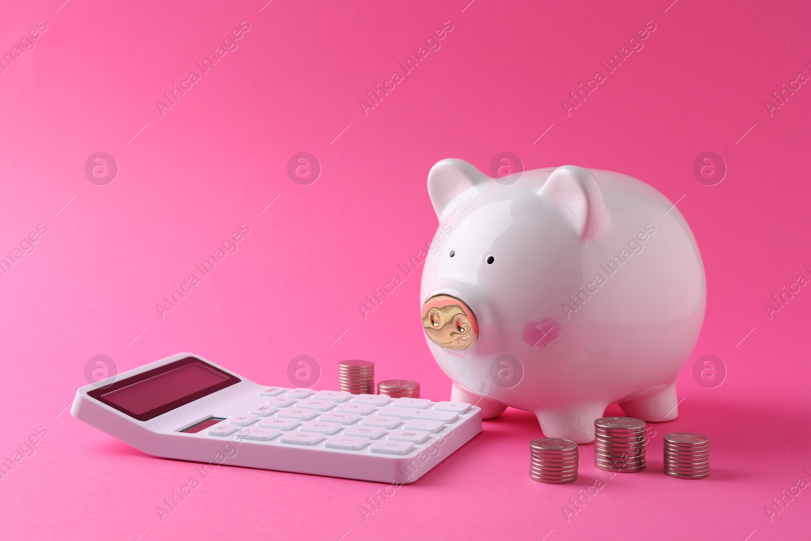 Photo of Financial savings. Piggy bank, coins and calculator on pink background