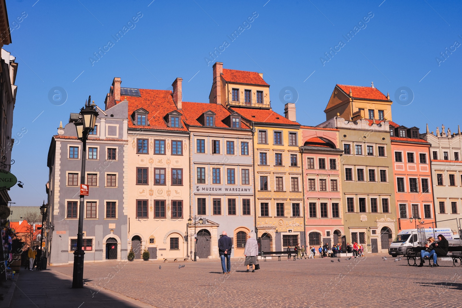 Photo of WARSAW, POLAND - MARCH 22, 2022: Beautiful view of Old Town city street on sunny day