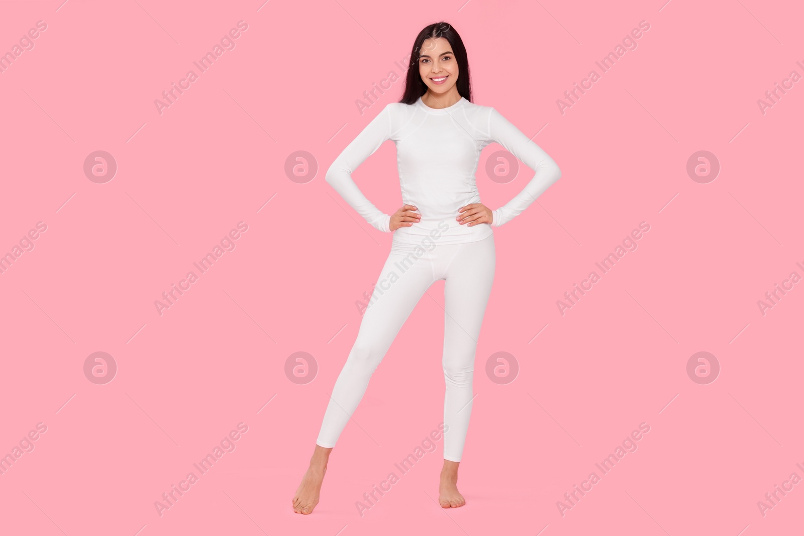 Photo of Woman in warm thermal underwear on pink background