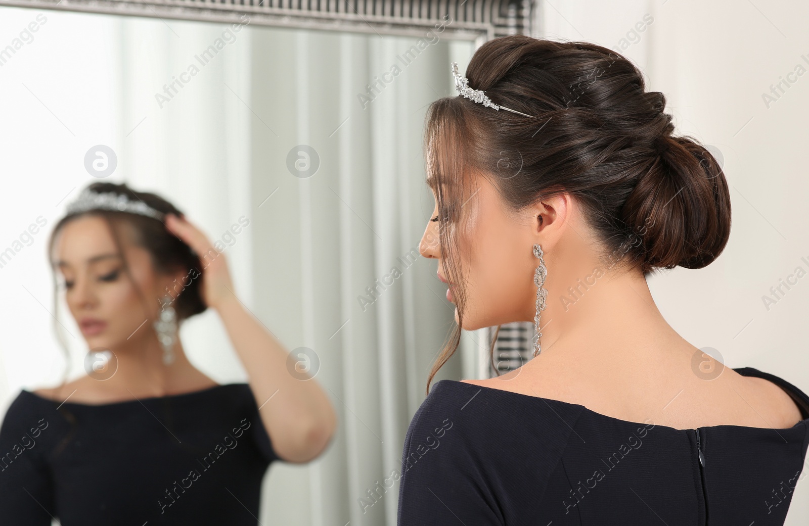 Photo of Beautiful young woman wearing luxurious tiara indoors