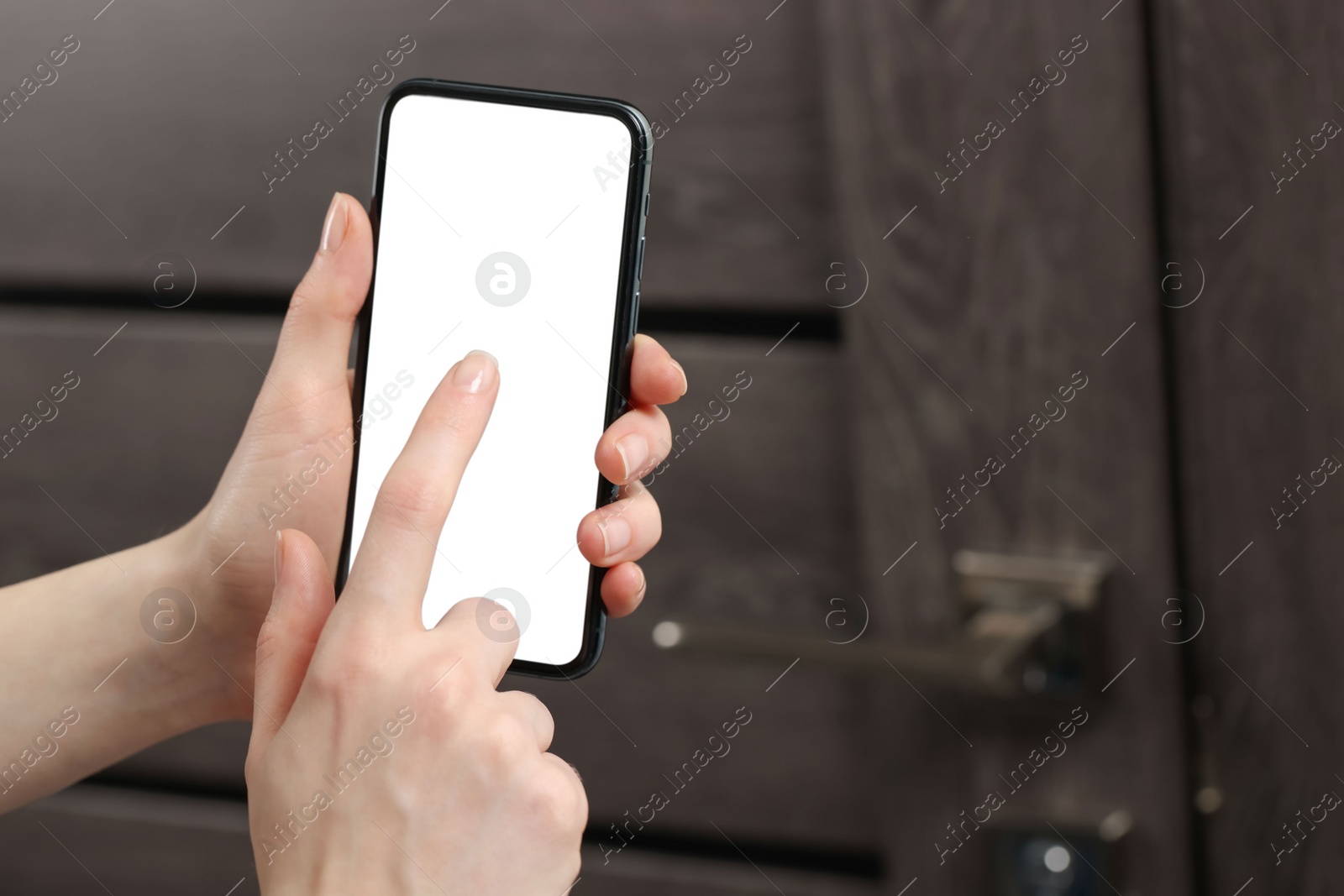 Photo of Woman unlocking door using smartphone, closeup view