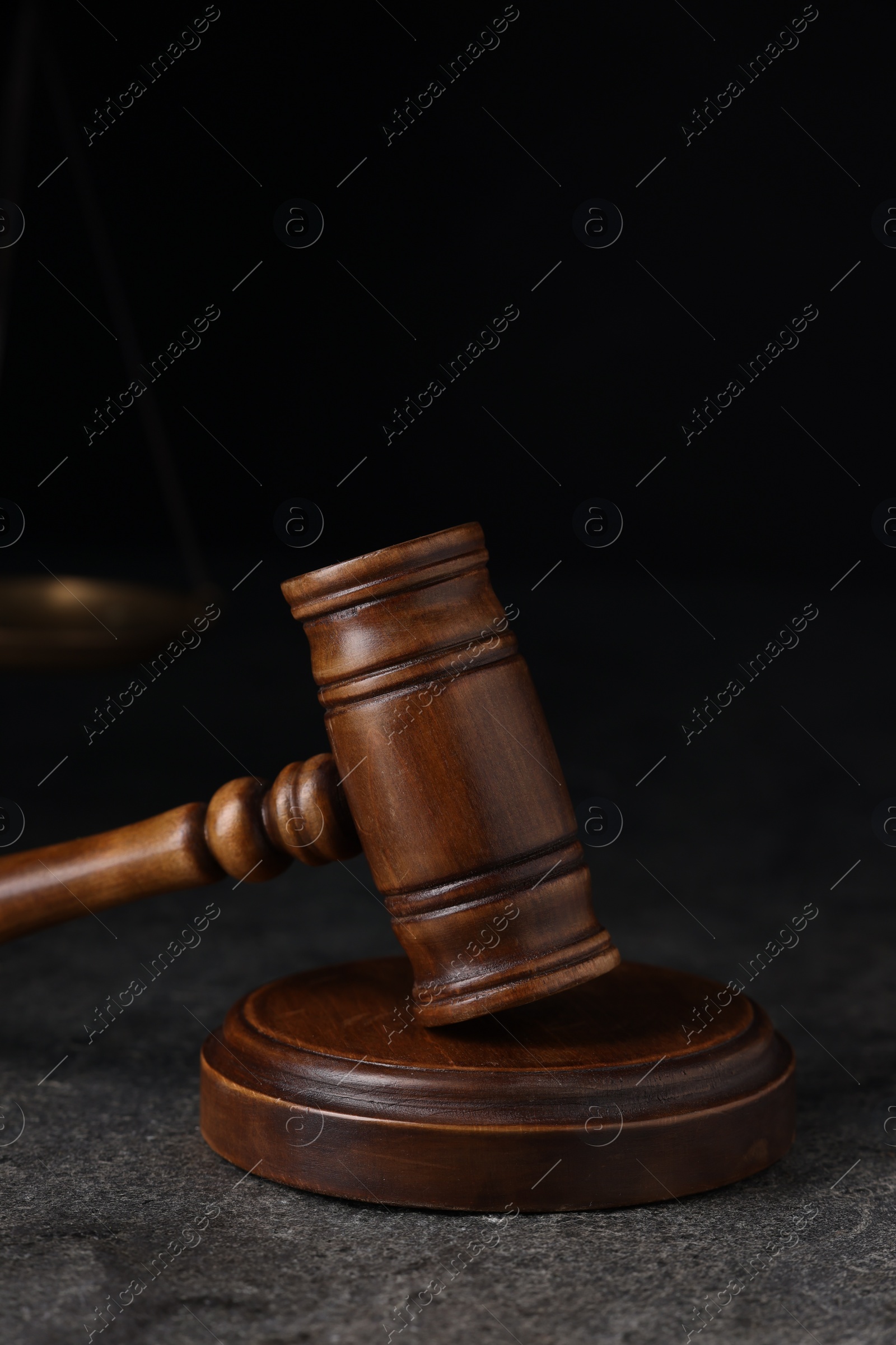 Photo of Law concept. Judge's gavel on grey textured table, closeup