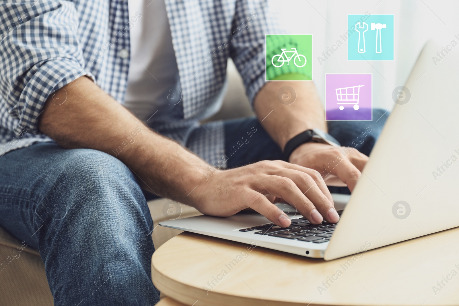 Image of Man using laptop at wooden table indoors, closeup. Online shopping