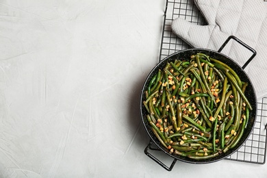 Photo of Yummy green beans with almonds in dish on table