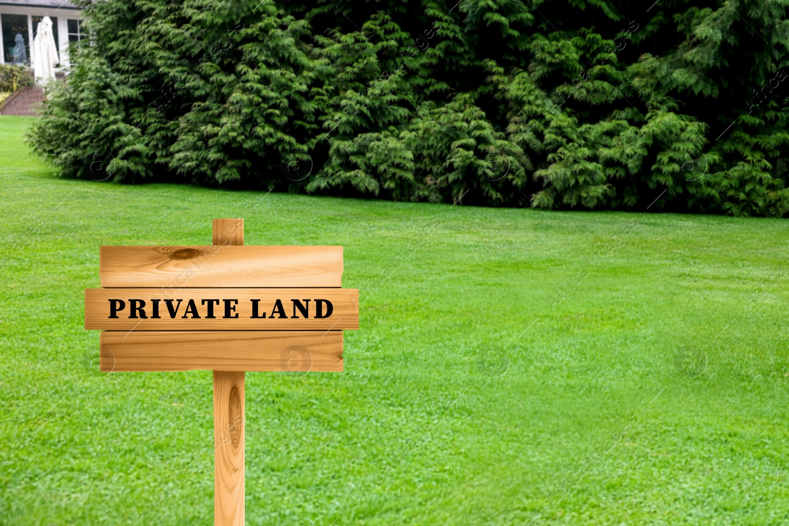 Image of Wooden sign with text Private Land on green lawn