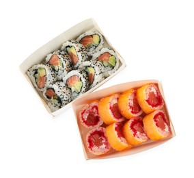 Photo of Food delivery. Paper boxes with different delicious sushi rolls on white background, top view