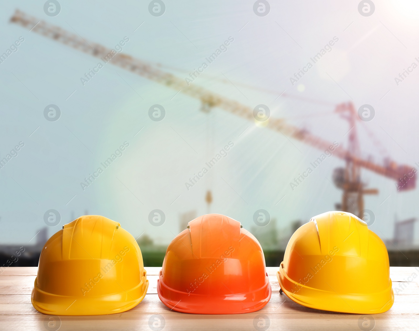 Image of Hard hats on wooden surface at construction site