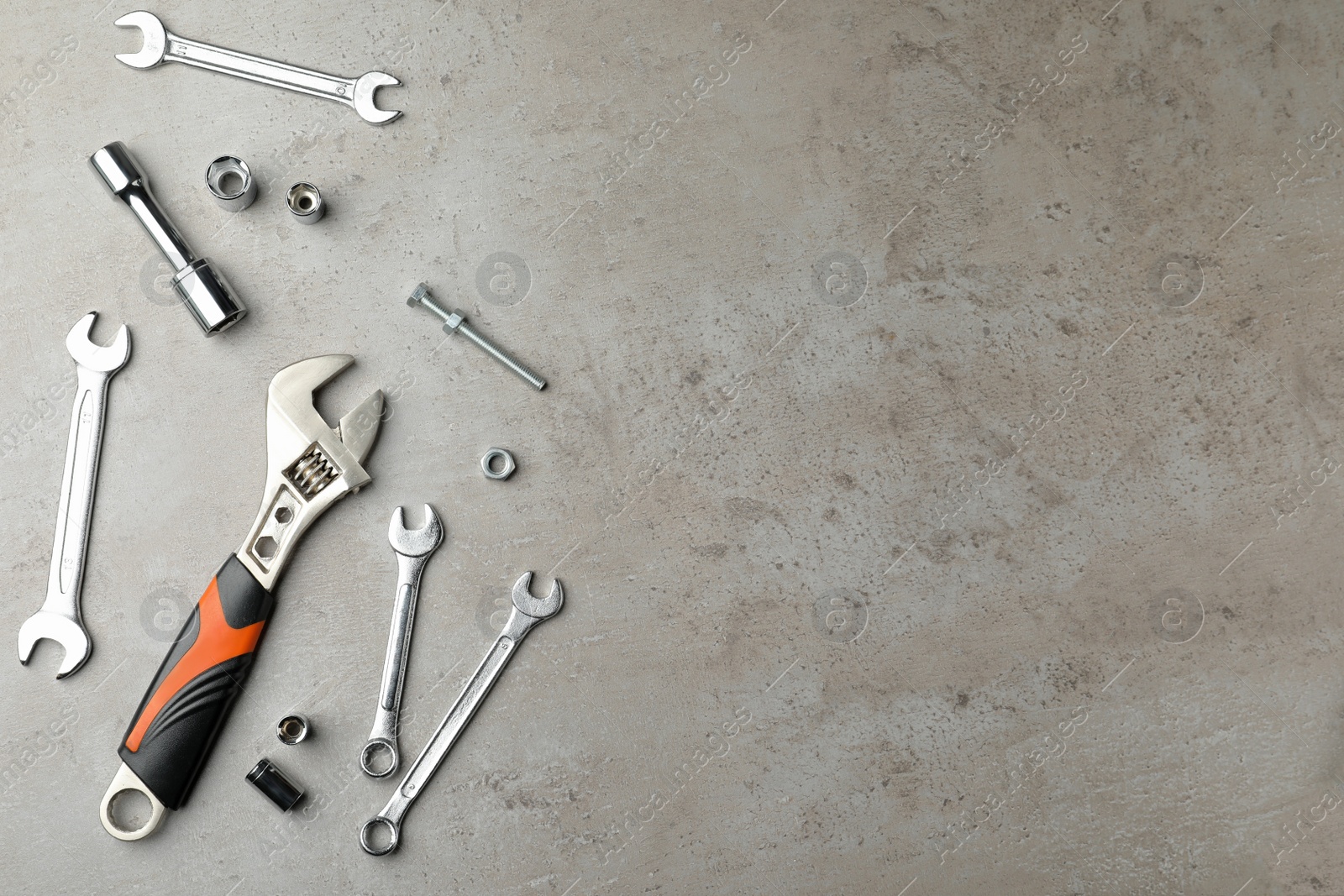 Photo of Auto mechanic's tools on grey background, flat lay. Space for text