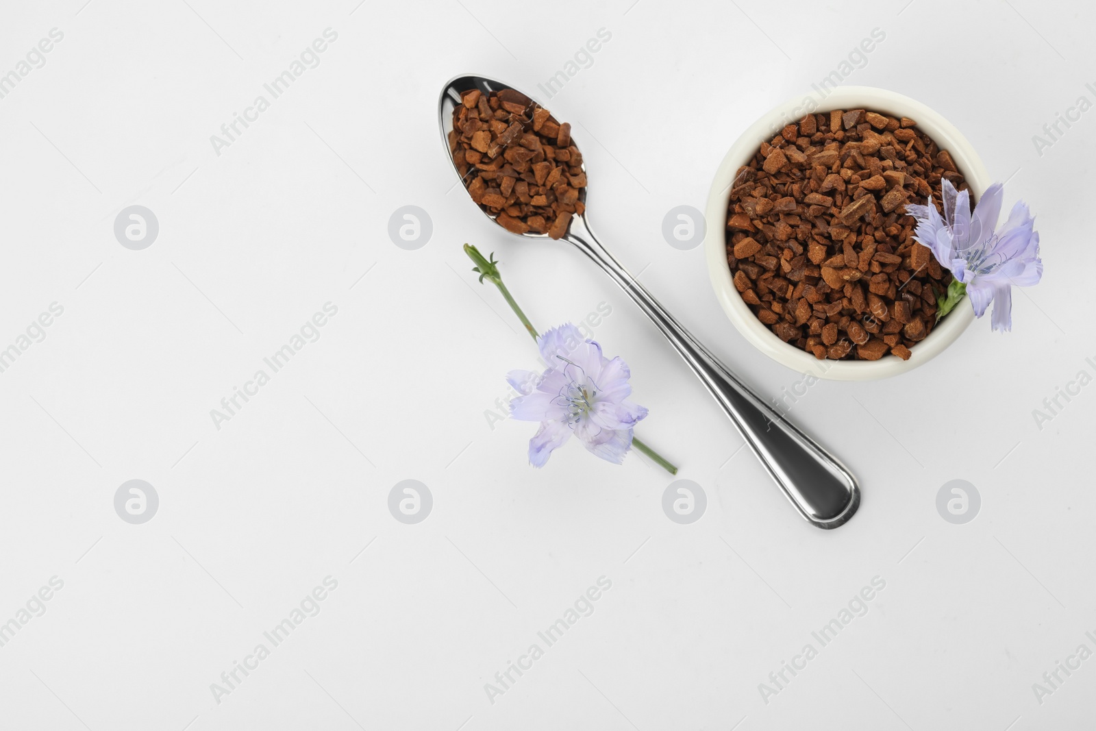 Photo of Chicory granules and flowers on white background, top view