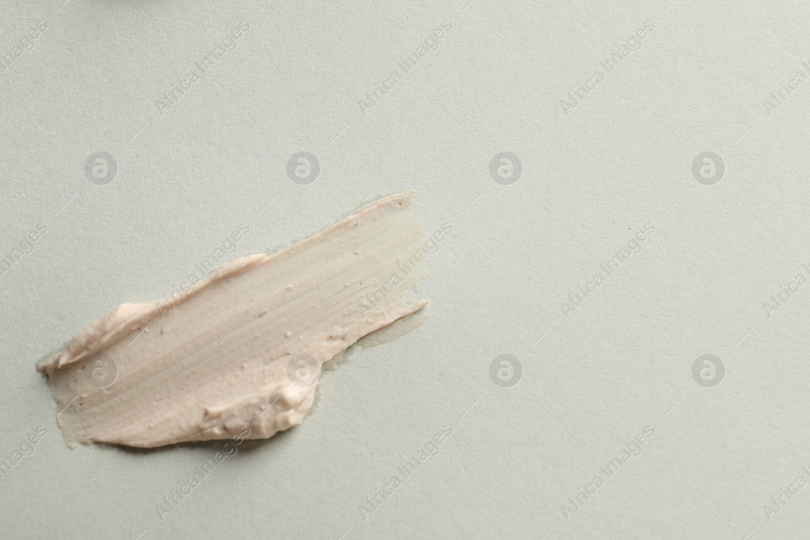 Photo of Sample of face mask on light background, top view. Space for text