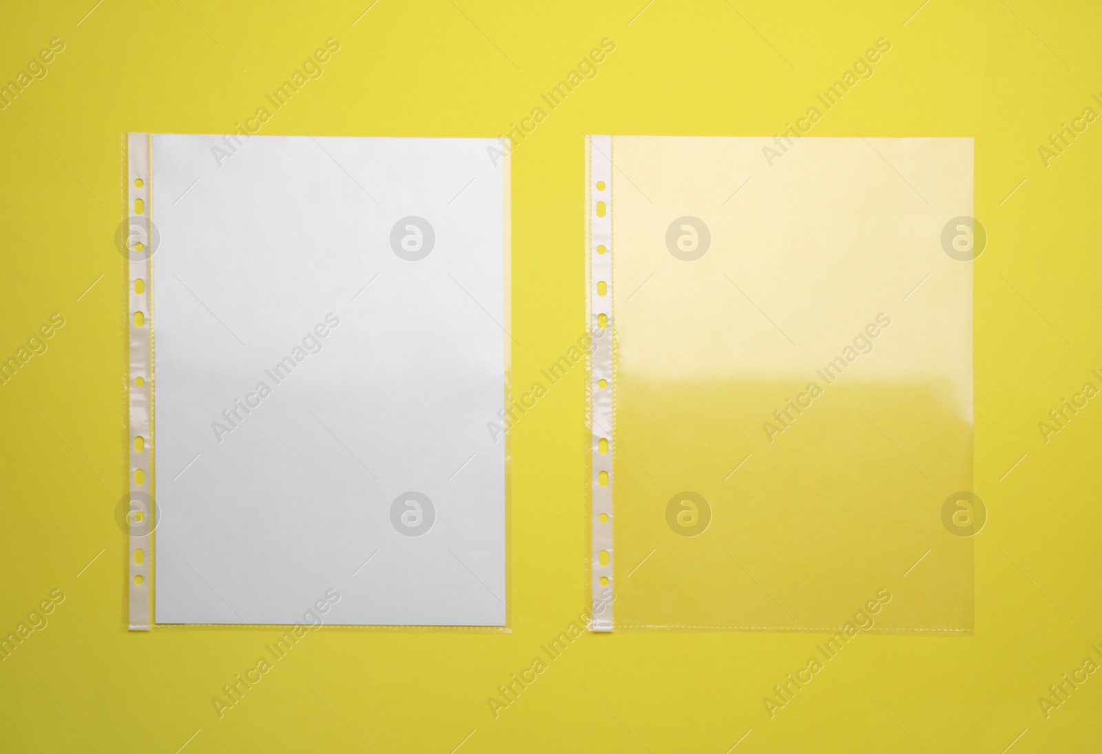 Photo of Punched pockets on yellow background, flat lay