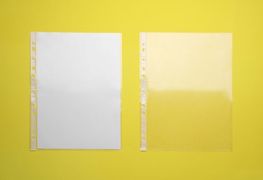 Photo of Punched pockets on yellow background, flat lay