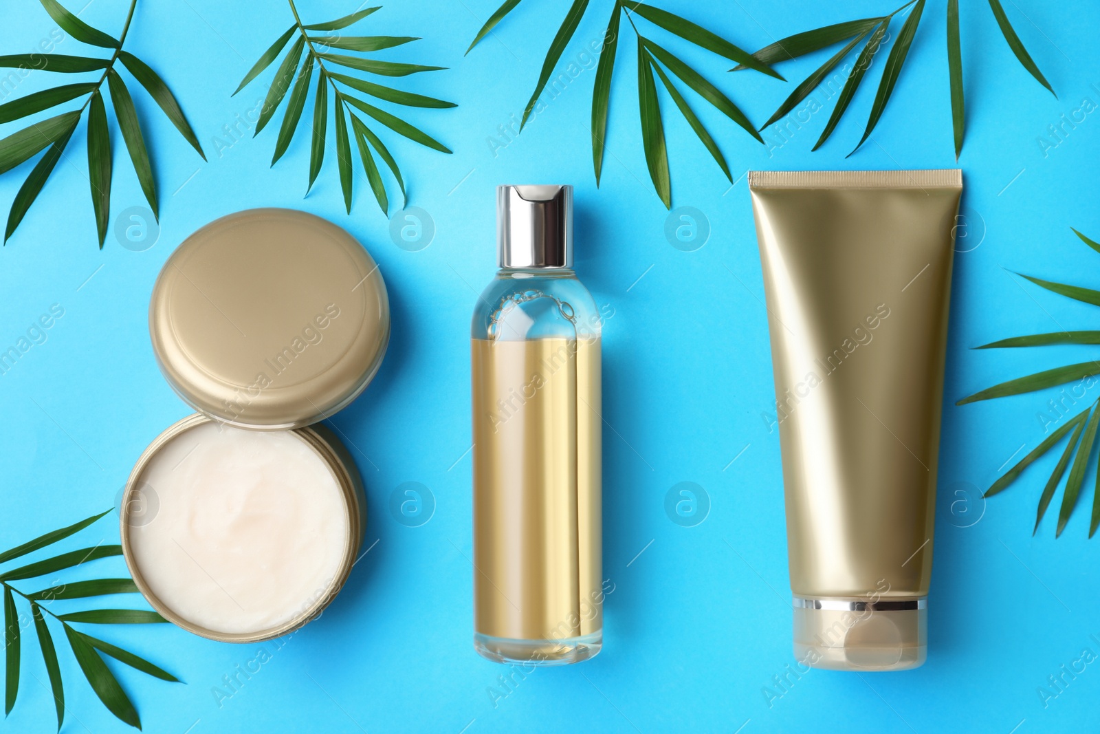 Photo of Flat lay composition with cosmetic products on blue background