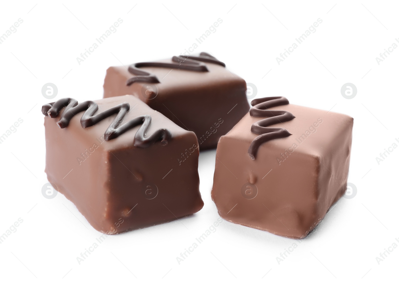 Photo of Delicious milk chocolate candies isolated on white