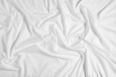 Crumpled white fabric as background, top view