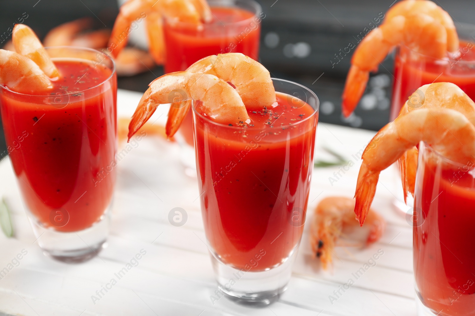 Photo of Delicious shrimp cocktail with tomato sauce served on table, closeup