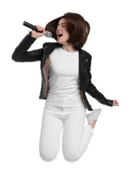 Photo of Beautiful young woman with microphone singing and jumping on white background